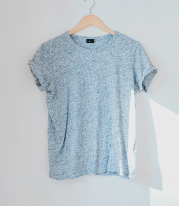hanged grey shirt on white wall
