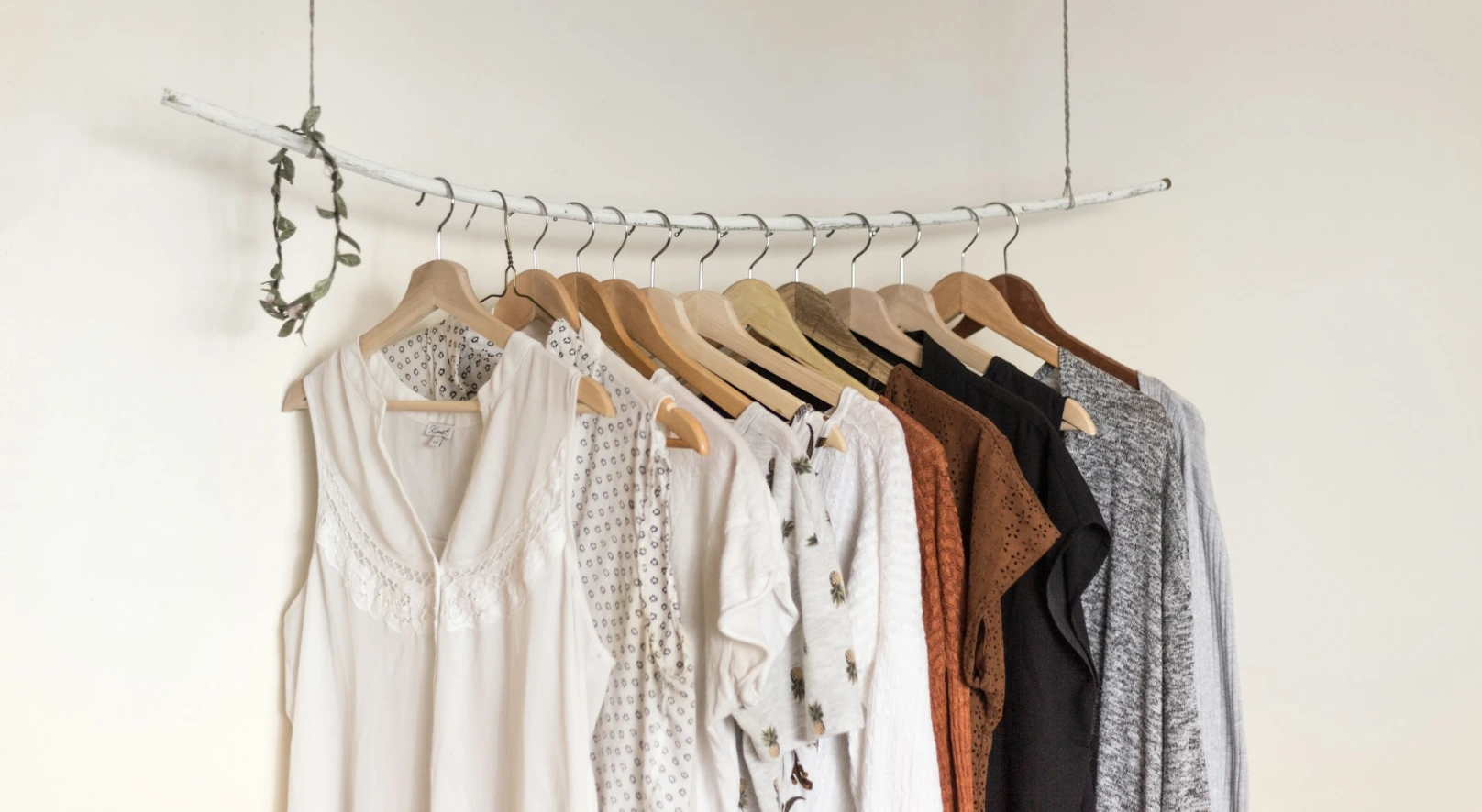 assorted clothes in wooden hangers